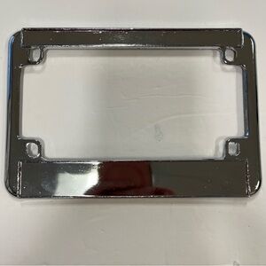 Chrome metal motorcycle license plate frame. Approximate size 8.25” x 6” flat